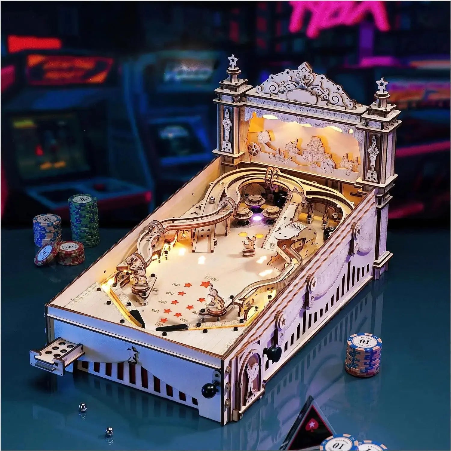 Detailed model of a pinball machine on a reflective surface with poker chips in the background.